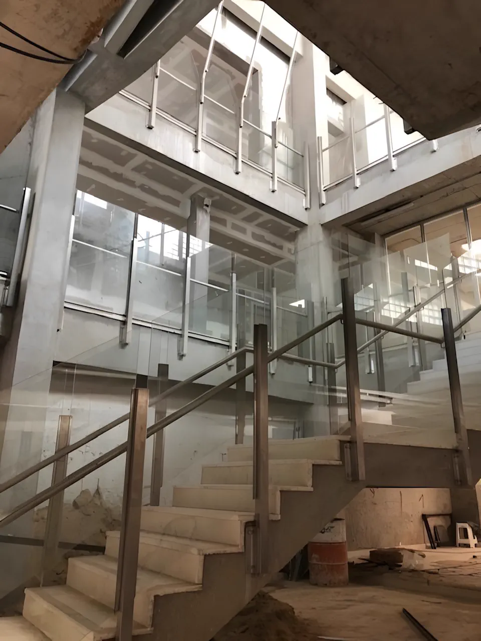 Escalera en obra vista desde abajo, con el pasamanos de madera