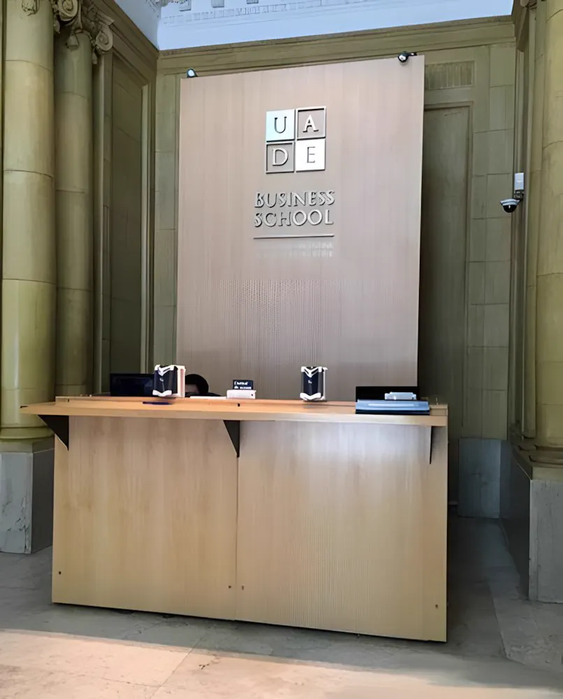 Recepción de UADE Business School con el cartel institucional